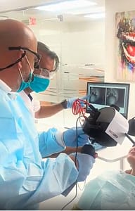 Dental staff performing 3D digital scan for implant-supported dentures with live image displayed on screen at Bella Smile Dentistry